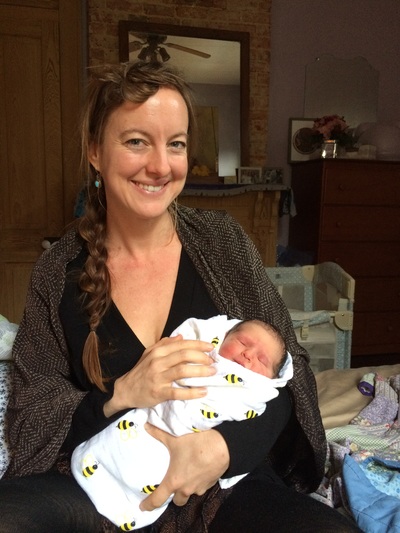 Effie Michot, CPM, LM holding newborn baby